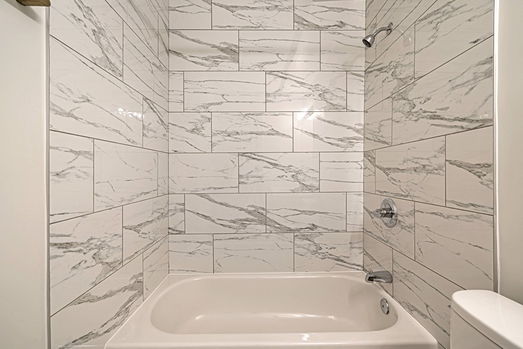 the ensuite shower and bathtub in a 555 waverly unit with marble