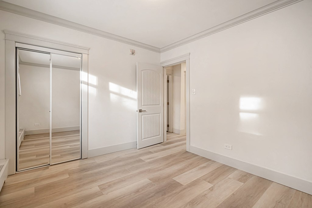 a living room with white walls and a sliding glass door