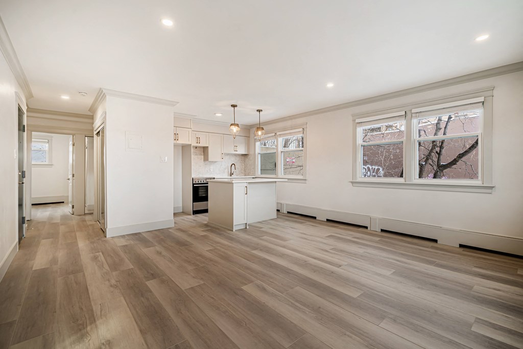 a renovated kitchen with white walls and white cabinets