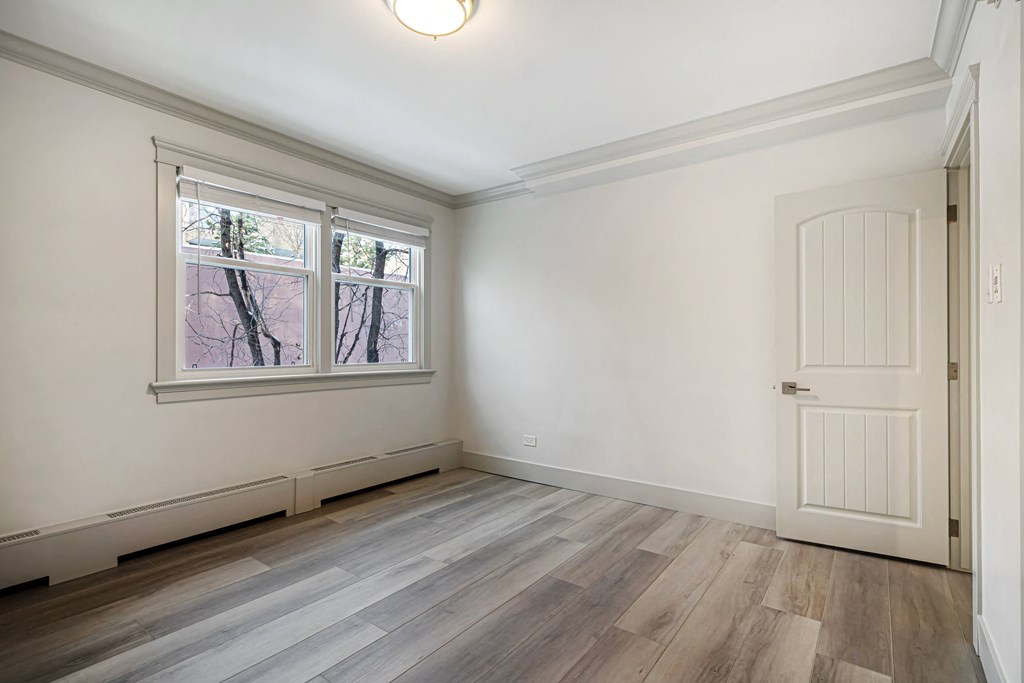 an empty room with white walls and a white door and window
