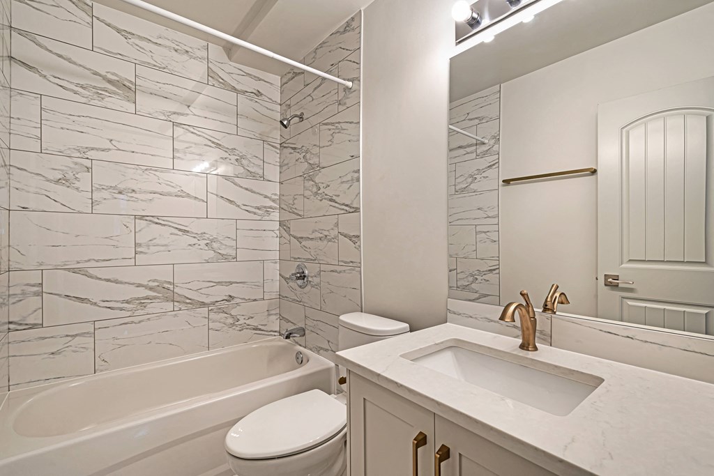 a bathroom with a sink toilet and a bath tub