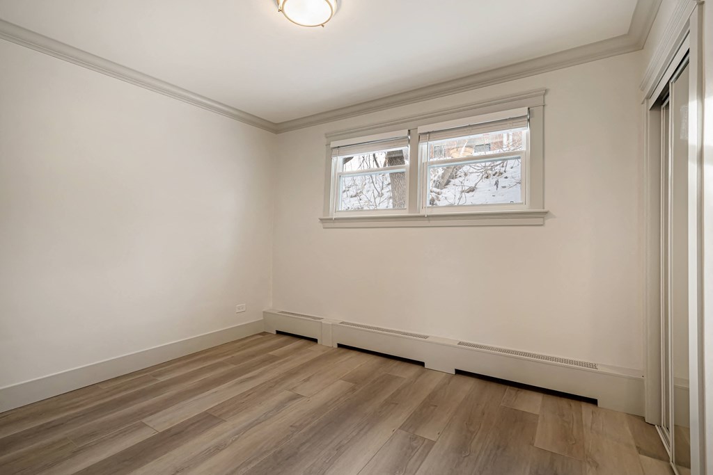 an empty room with white walls and a window