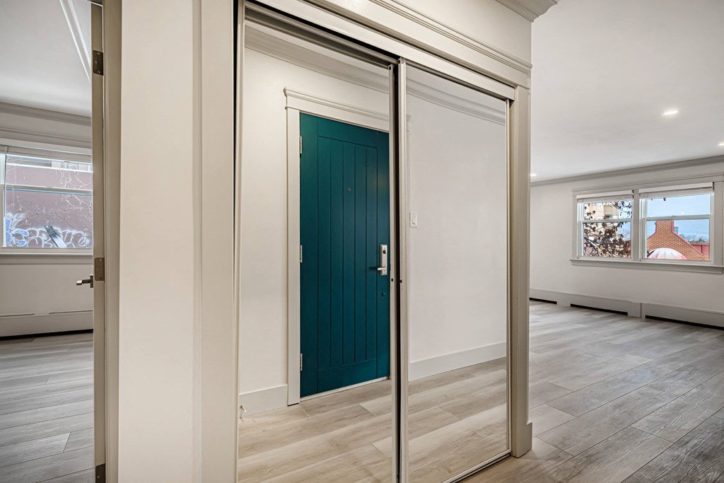 a door is open in a room with white walls and wood floors