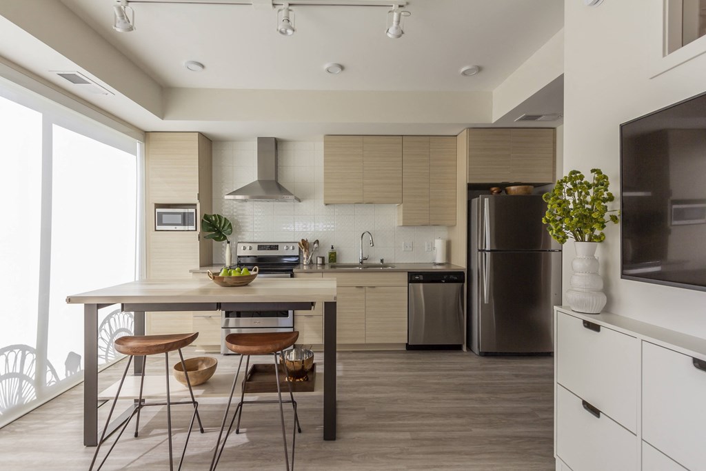 a kitchen with a table and chairs and a refrigerator