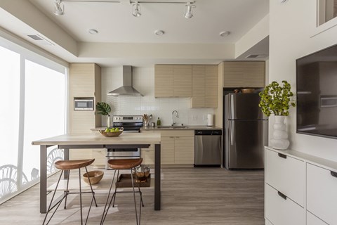 a kitchen with a table and chairs and a refrigerator
