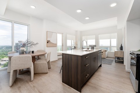 A modern kitchen with a dining table and chairs.