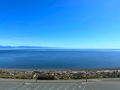A parking lot with a view of the ocean.