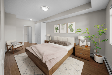 a bedroom with white walls and wood floors and a bed