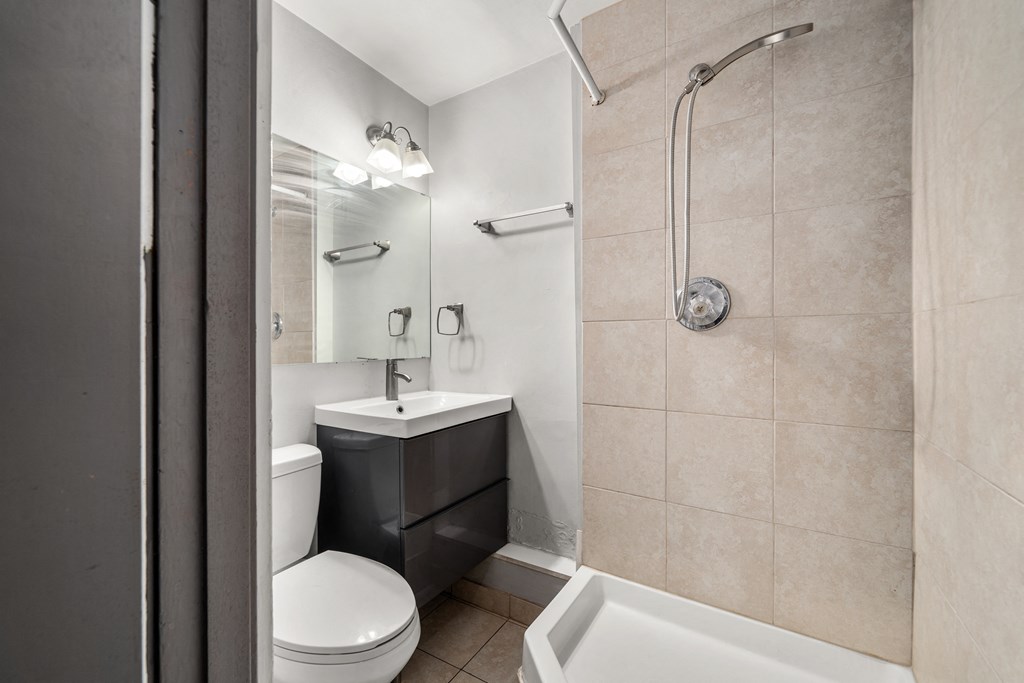 a bathroom with a shower toilet and a sink