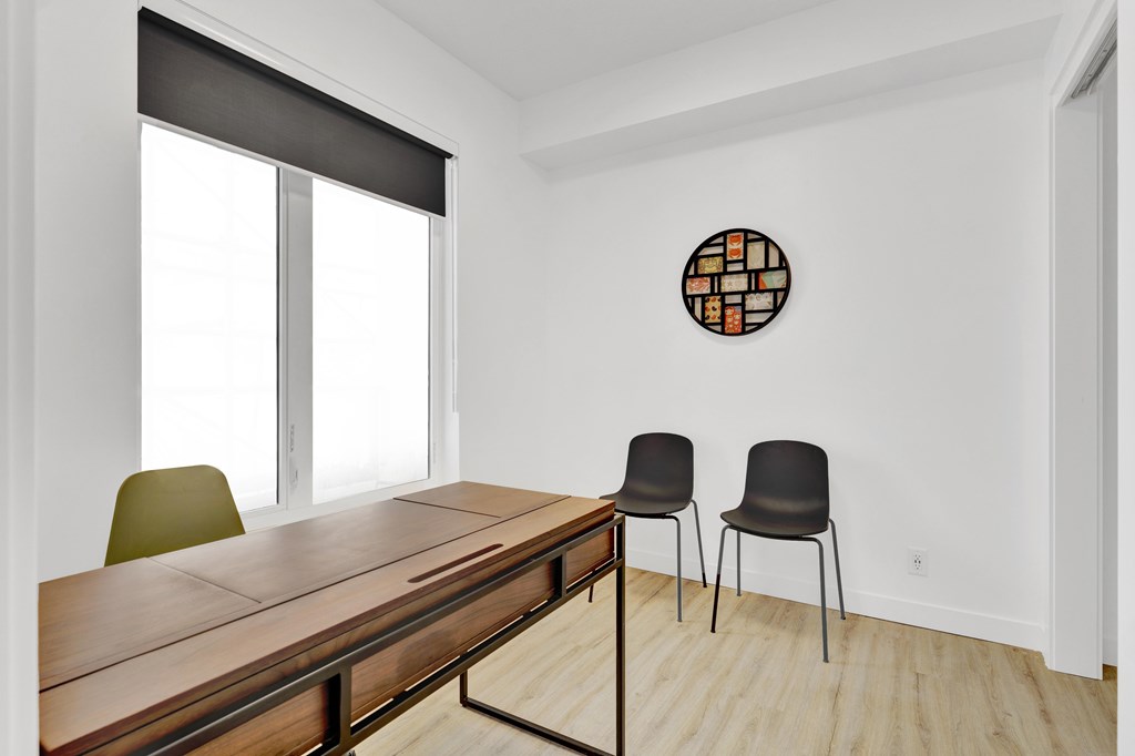 A conference room with a long table and two chairs.