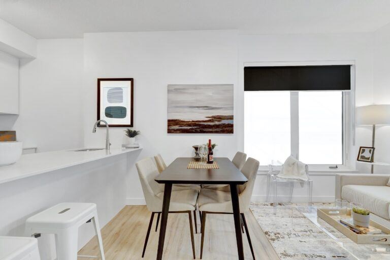 A modern dining room with a wooden table and chairs.