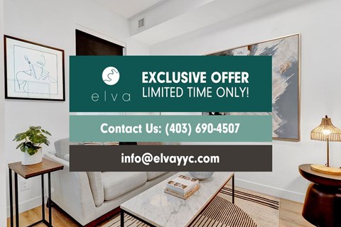 A living room with a couch, a small table, and a painting on the wall.