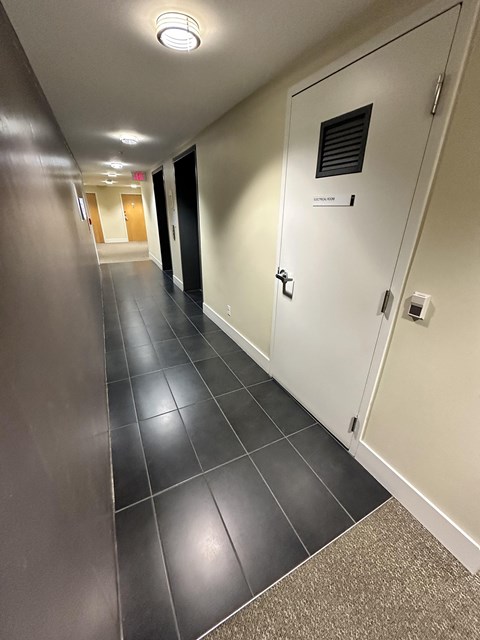 A long hallway with a door on the right.