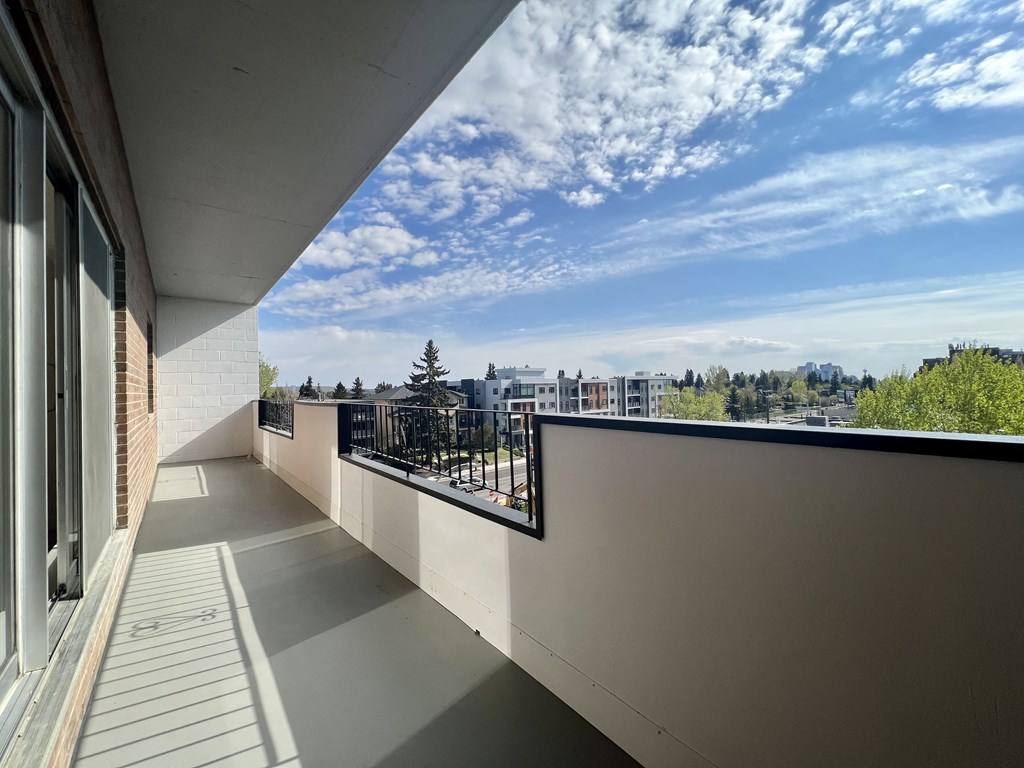 a balcony with a view of the city and a blue sky