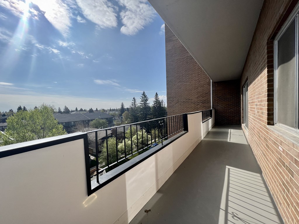 a balcony with a view of the city and a blue sky