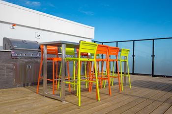 A set of four colorful chairs are arranged around a table.