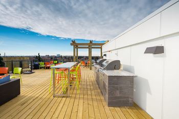 A wooden deck with a table and chairs.
