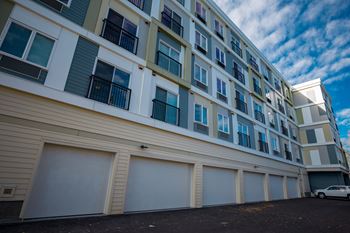 A large building with a white car parked in front.
