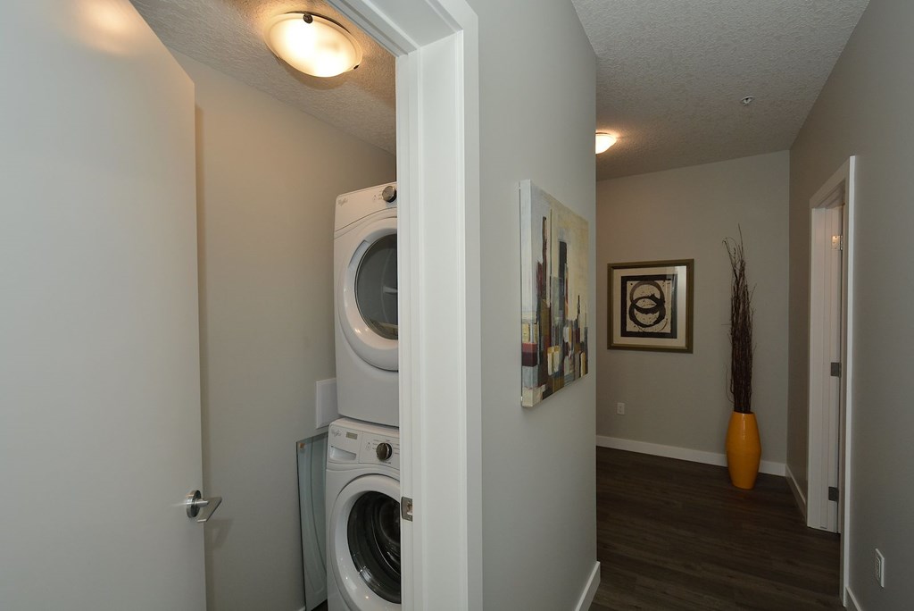 A white washer and dryer in a small room.