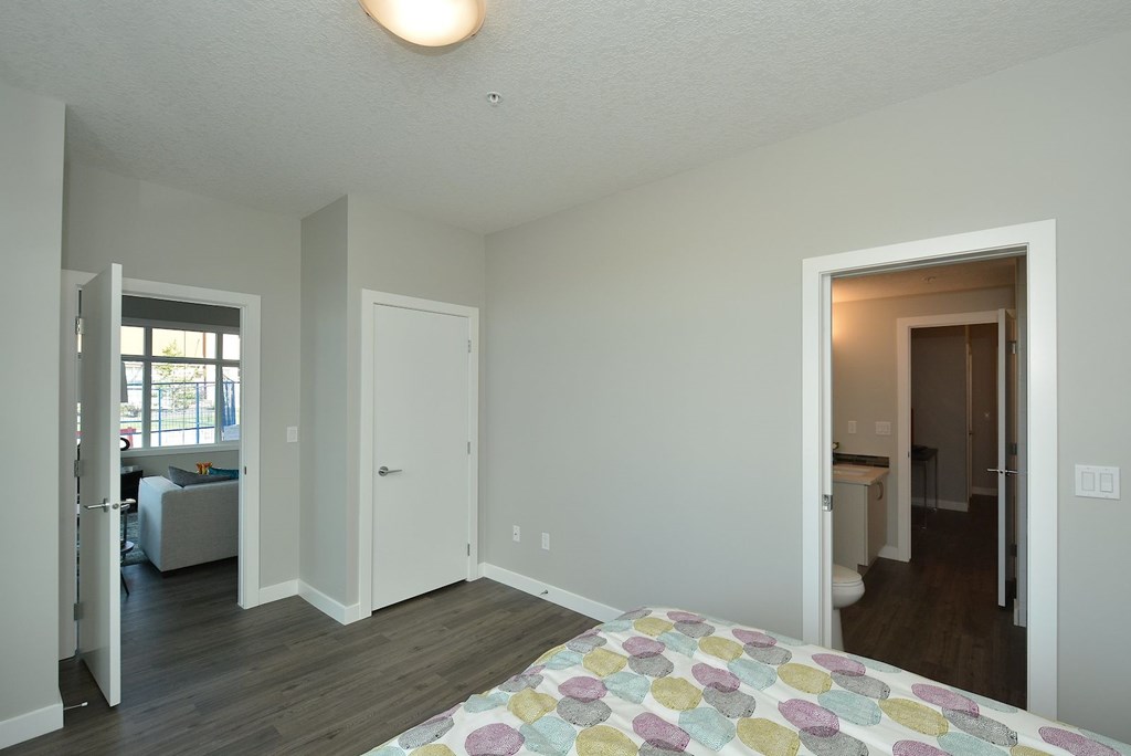 A bedroom with a bed and a window.