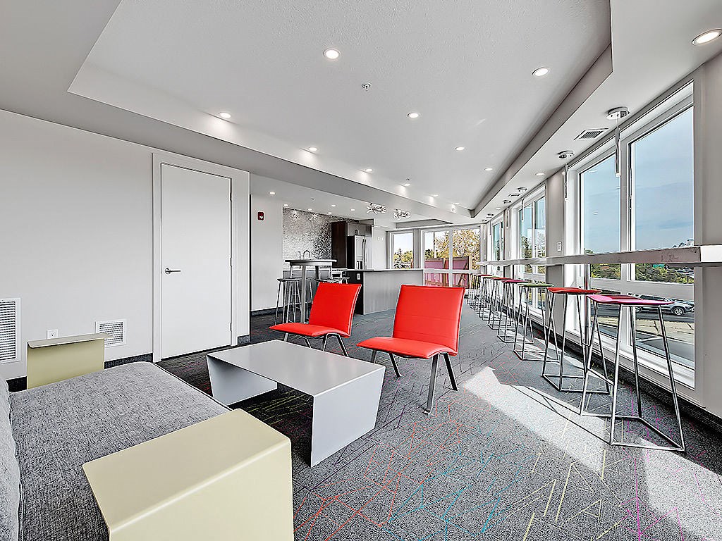 A conference room with a long table and chairs.