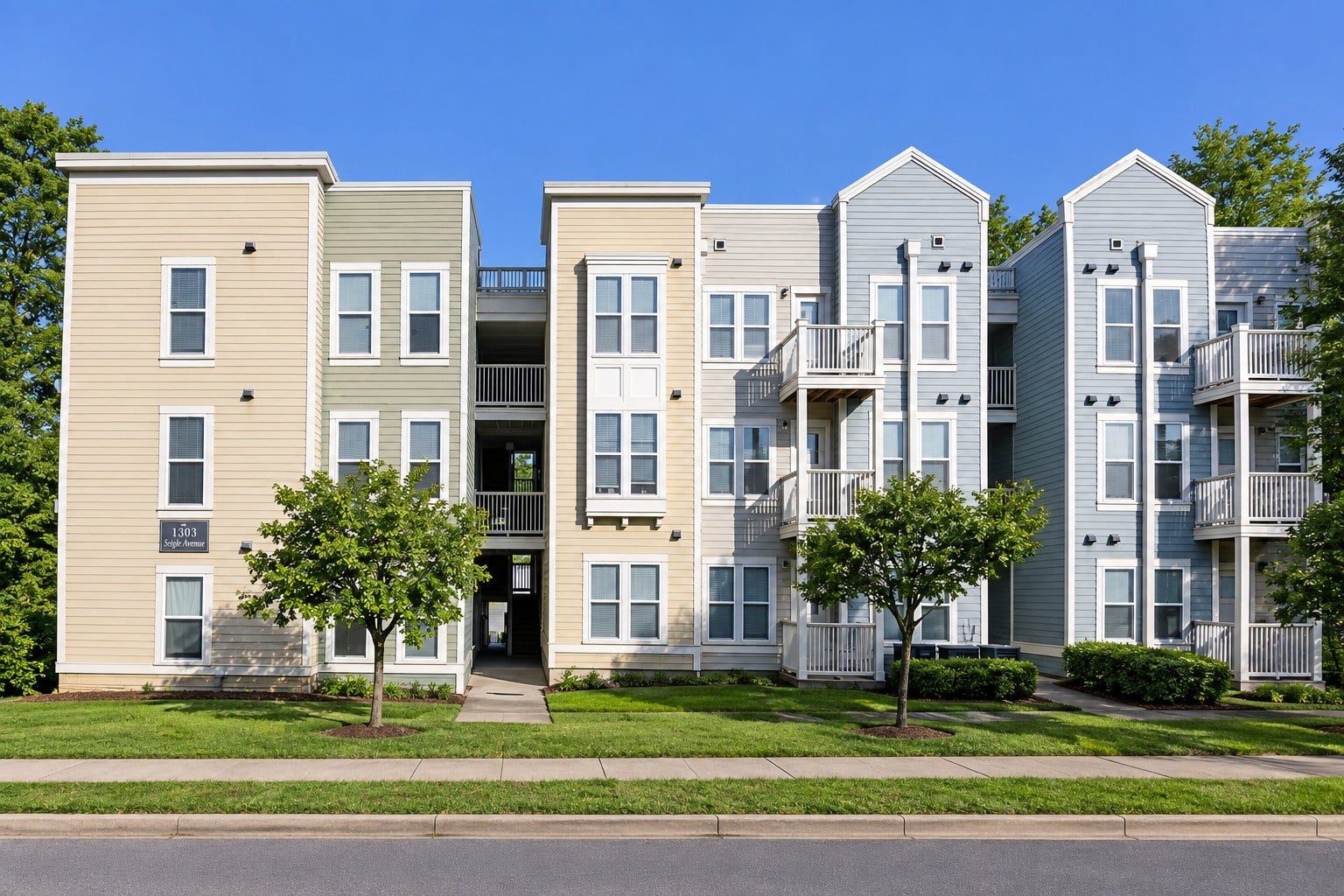 Apartment building with a mix of beige and grey exterior walls.