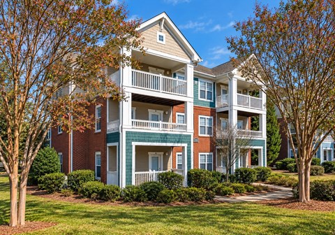 A large two story apartment building with a balcony on the second floor.