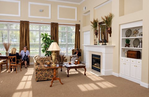 A living room with a fireplace and a large window.