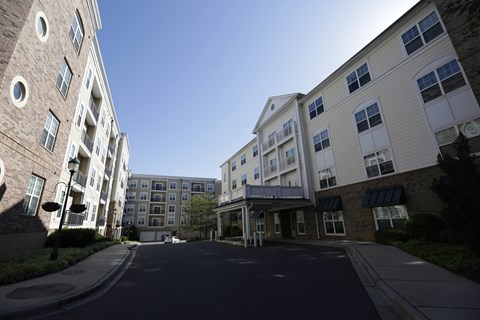 A street view of a residential area with two-story buildings on either side.