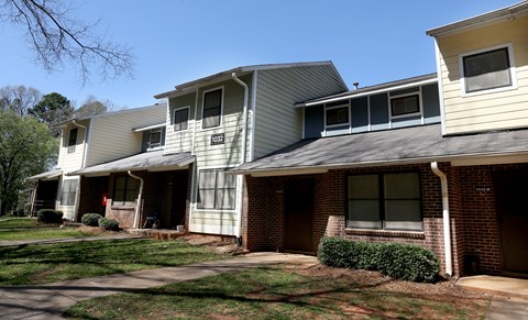 A row of houses with a clear blue sky above them.