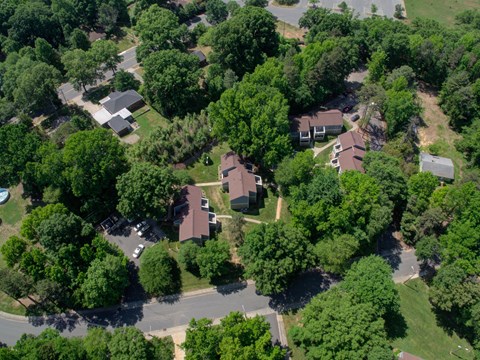 A bird's eye view of a residential area with houses and trees.