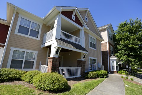 A two-story apartment building with a red and beige exterior.