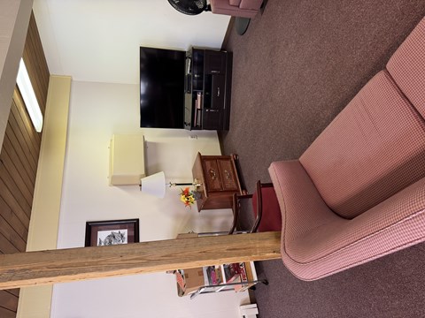 A living room with a couch and a television.