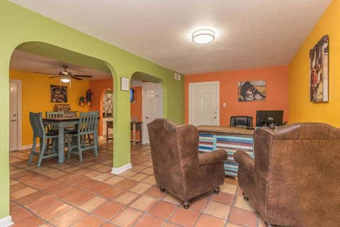 A living room with a brown chair and a brown couch.