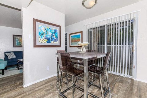 A dining room with a table and chairs.