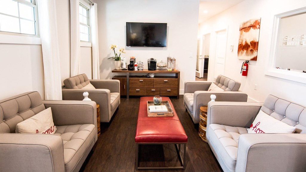 a living room with couches and chairs and a table