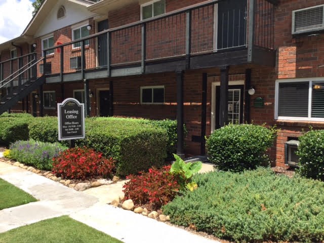 a sidewalk in front of a building with a sign