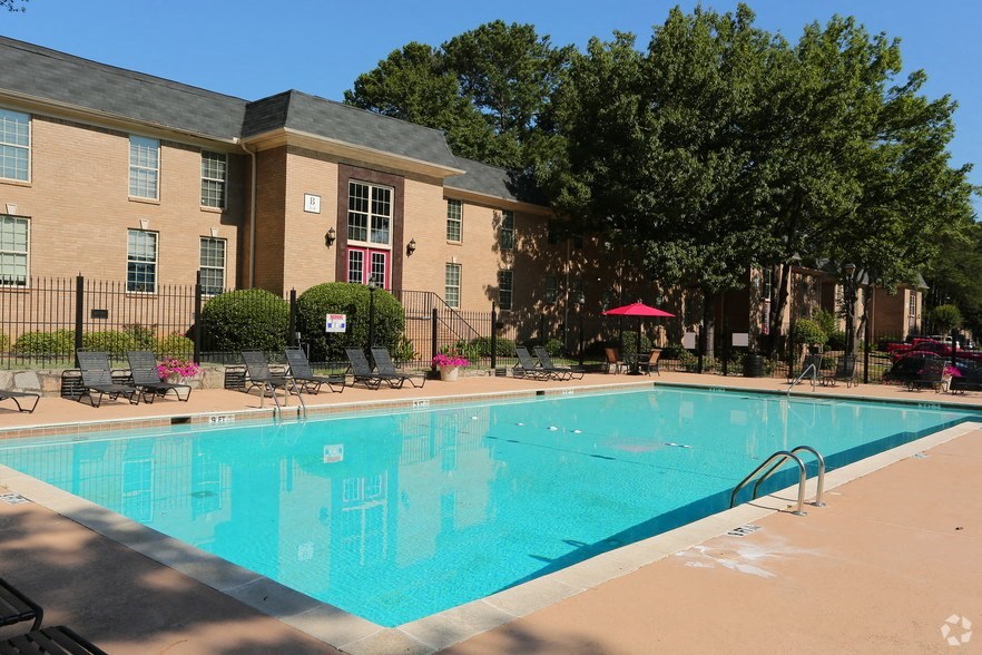 a large swimming pool in front of a building