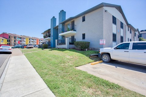 a white truck parked in front of an apartment building