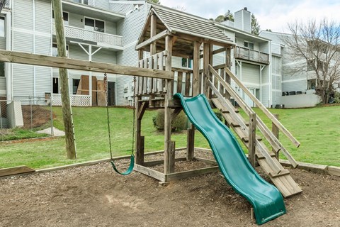 A green slide is the main feature of this playground.