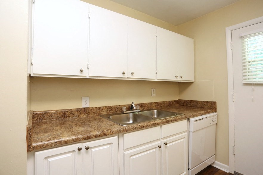 a kitchen with white cabinets and a sink