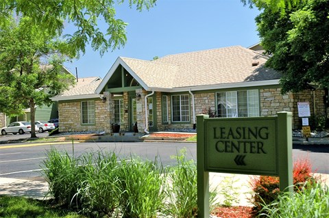 a leasing center sign in front of a house