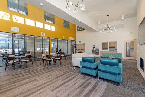 A modern living room with a blue couch and wooden floors.