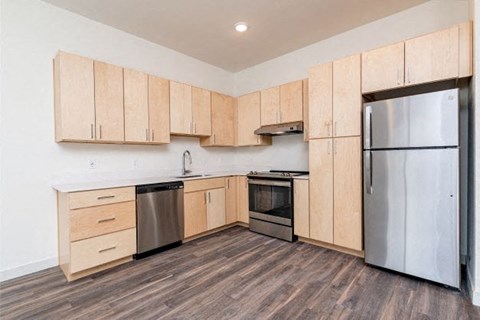 A kitchen with wooden cabinets and stainless steel appliances.