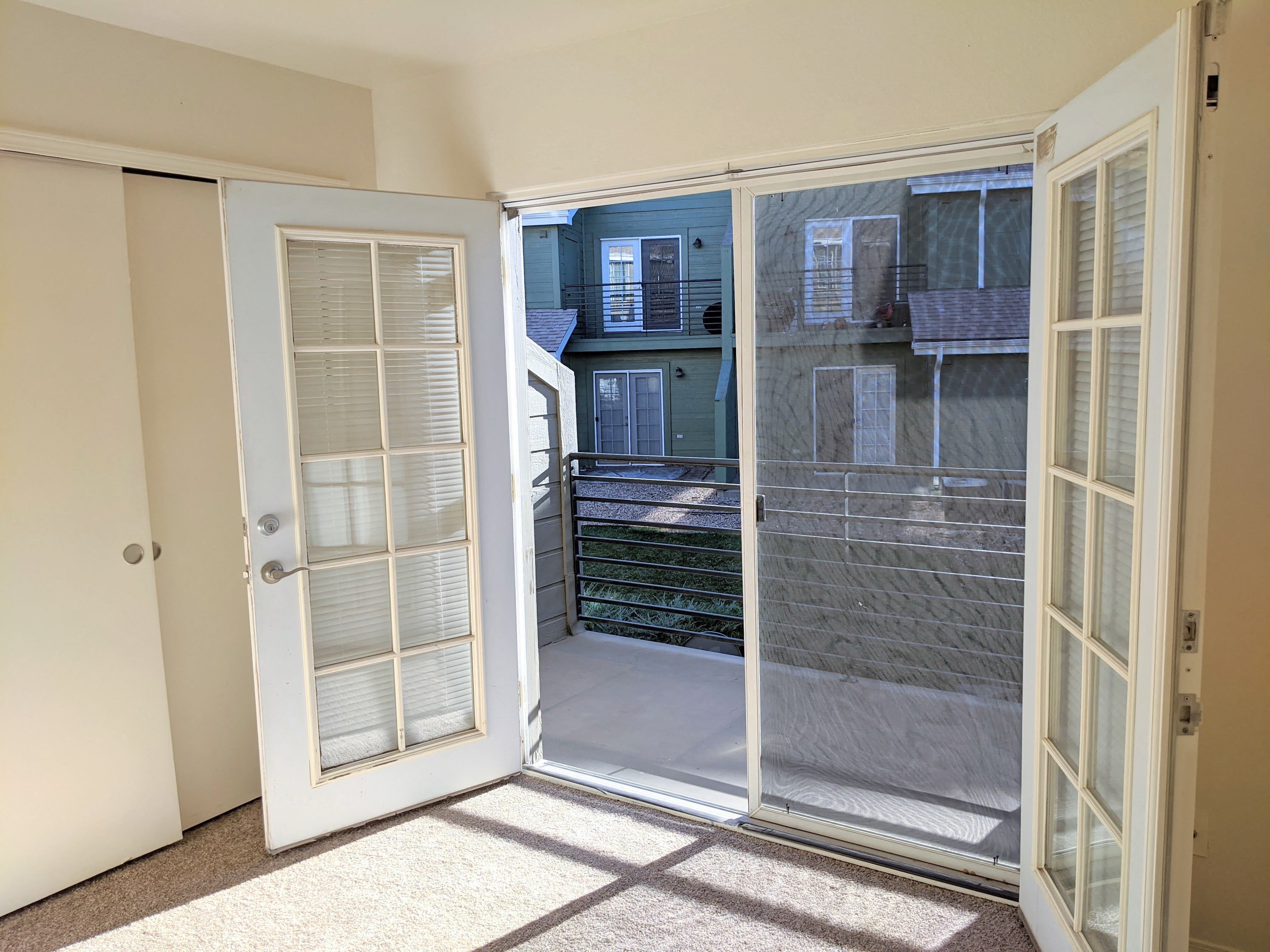 French doors in main floor bedroom open up to patio