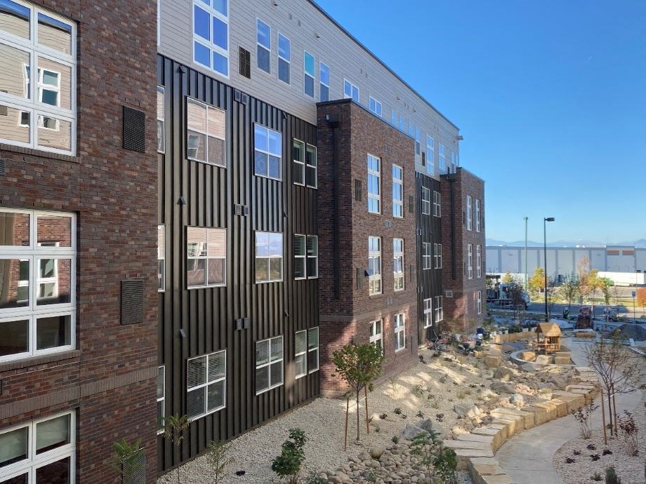 a large brick building with a courtyard in front of it
