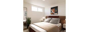 A bedroom with a large bed and a painting on the wall.