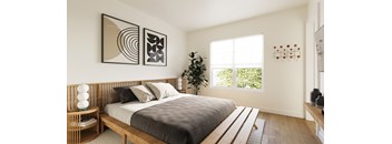 A bedroom with a large bed and two framed artworks on the wall.