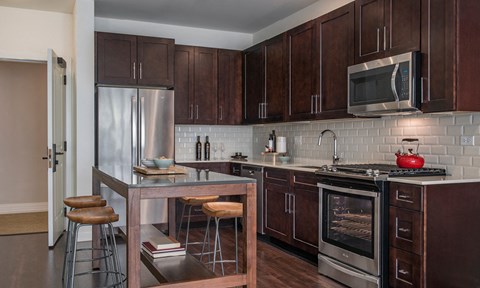a kitchen with wooden cabinets and stainless steel appliances
