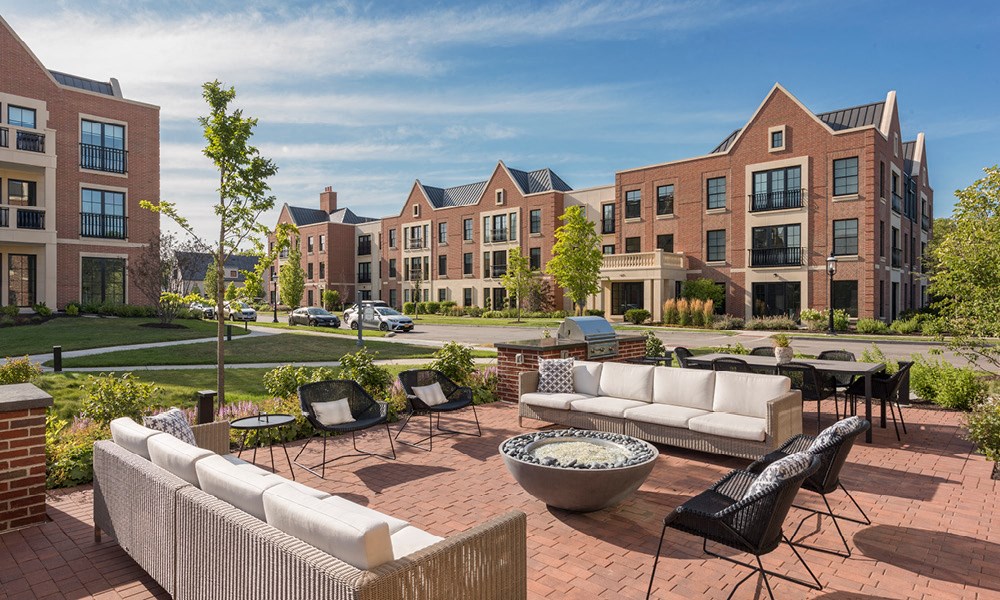 outdoor lounge area with a firepit and grilling stations